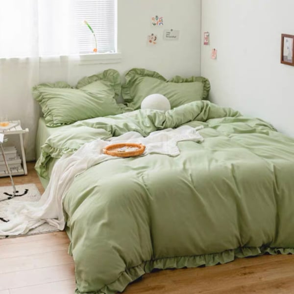 white bedding with green pillows